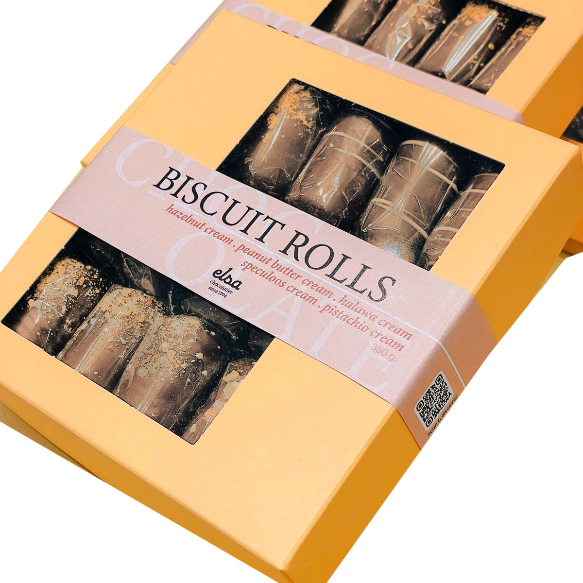 Close-up of a biscuit rolls gift box with a window revealing decorated chocolate rolls