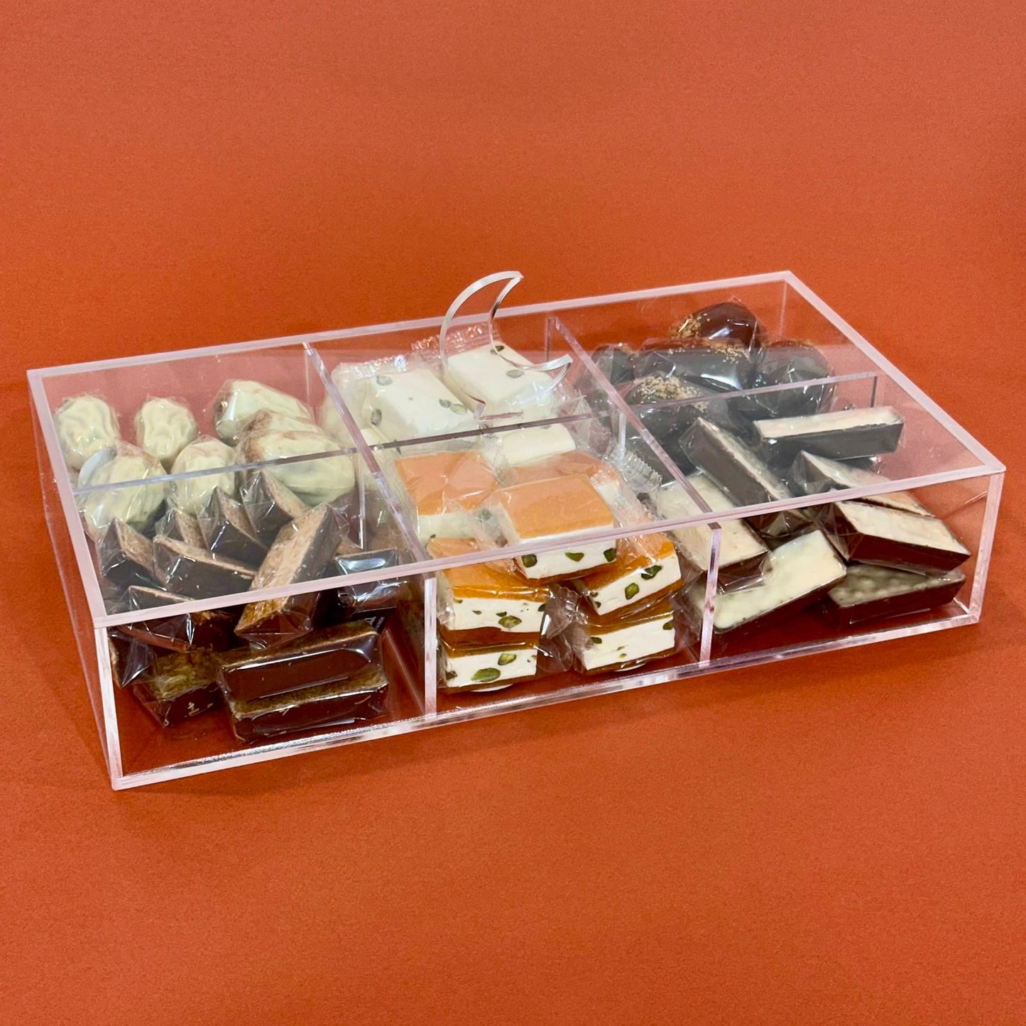 Gift box with compartments filled with various Ramadan treats