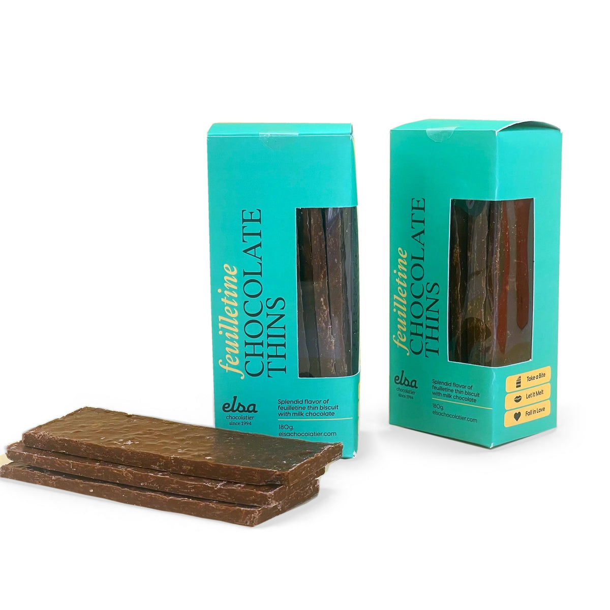 Feuilletine milk chocolate thins stacked beside two turquoise window boxes