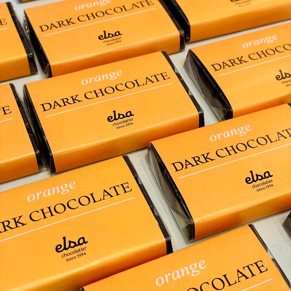 Orange Dark Chocolate Bars in orange wrappers arranged in rows