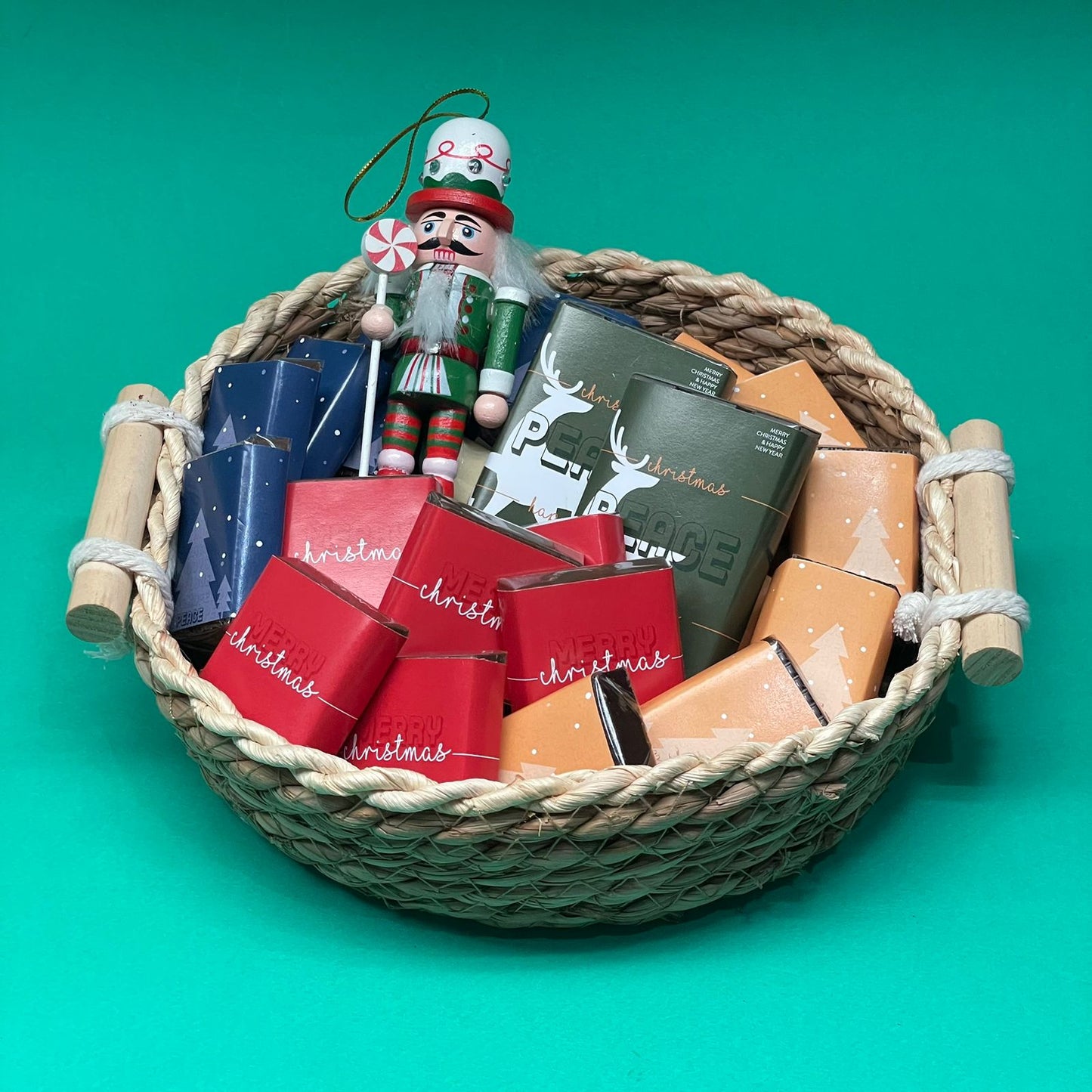 whicker chocolate gift basket filled with chooclate pieces and christmas decoration