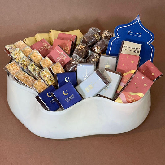 Assorted Ramadan sweets in a curve-shaped vase.