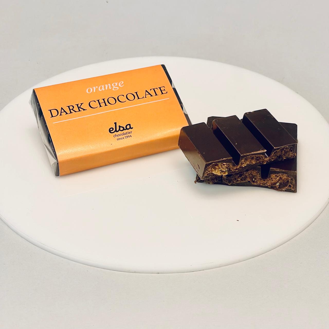 an open dark chocolate bar on a plate
