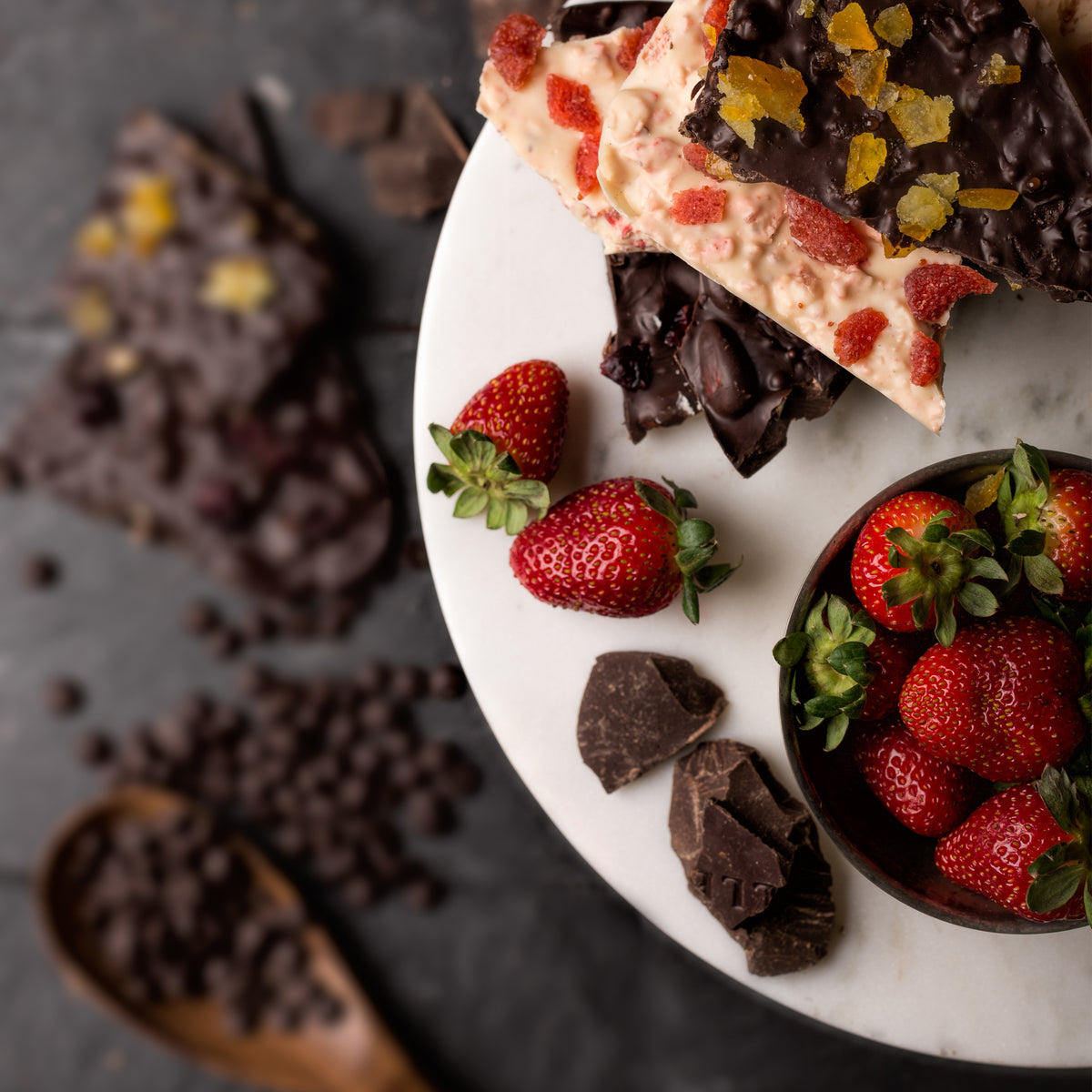 Chocolate and strawberries arranged on a marble table