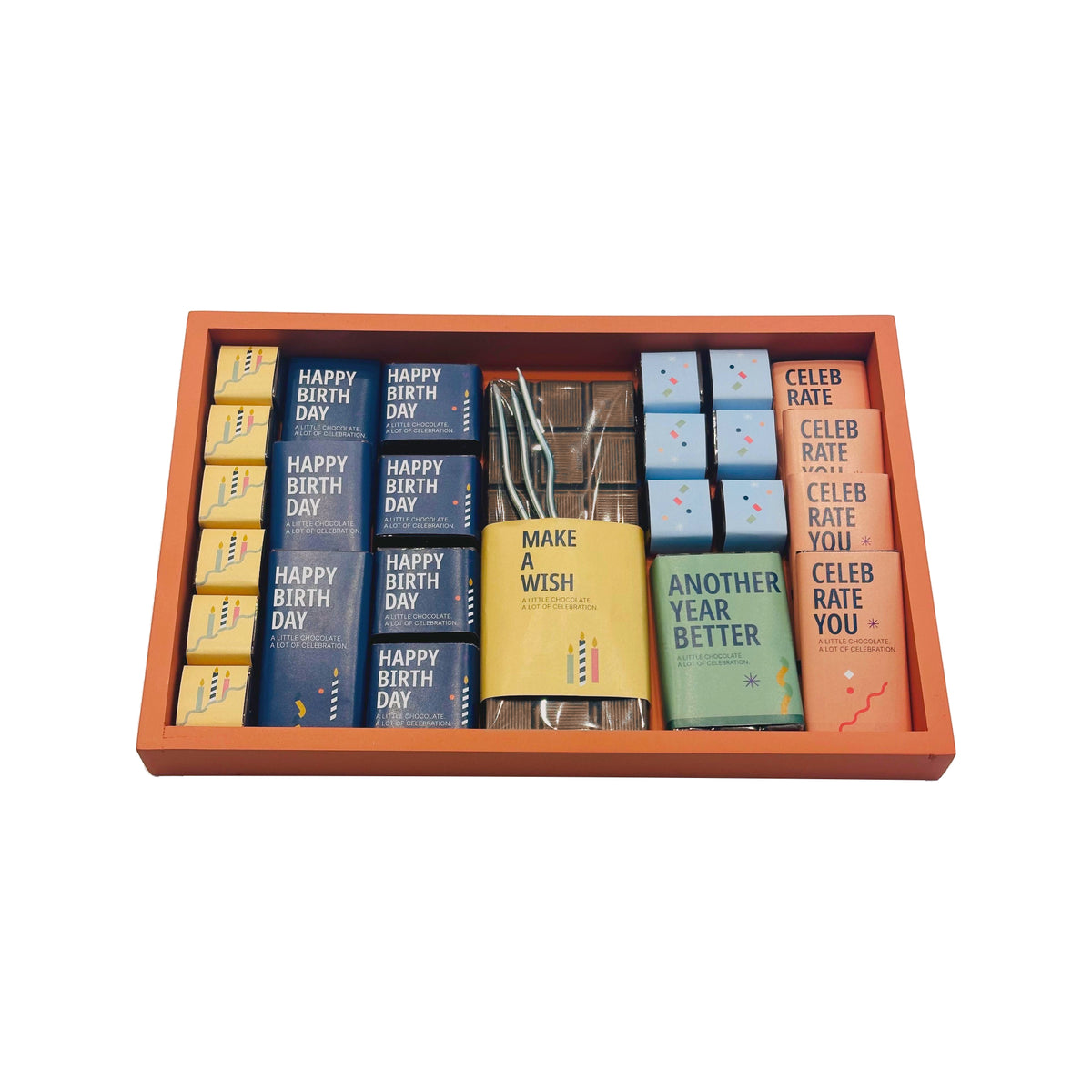 Birthday chocolate assortment presented in an orange tray on a white background