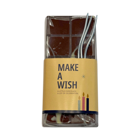 Birthday chocolate tablet with Make a Wish sleeve and candles on a white background