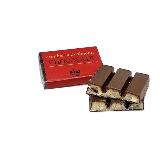 Cranberry and almond milk chocolate mini bar with its red wrapper and two stacked pieces showing the filling