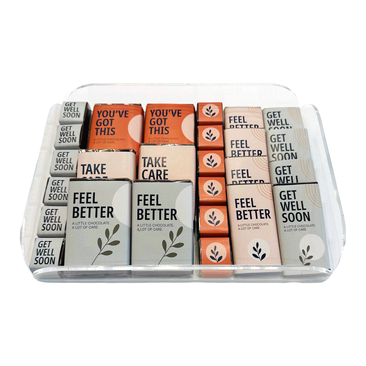 Get Well Soon chocolate assortment presented in a clear plexi tray on a white background